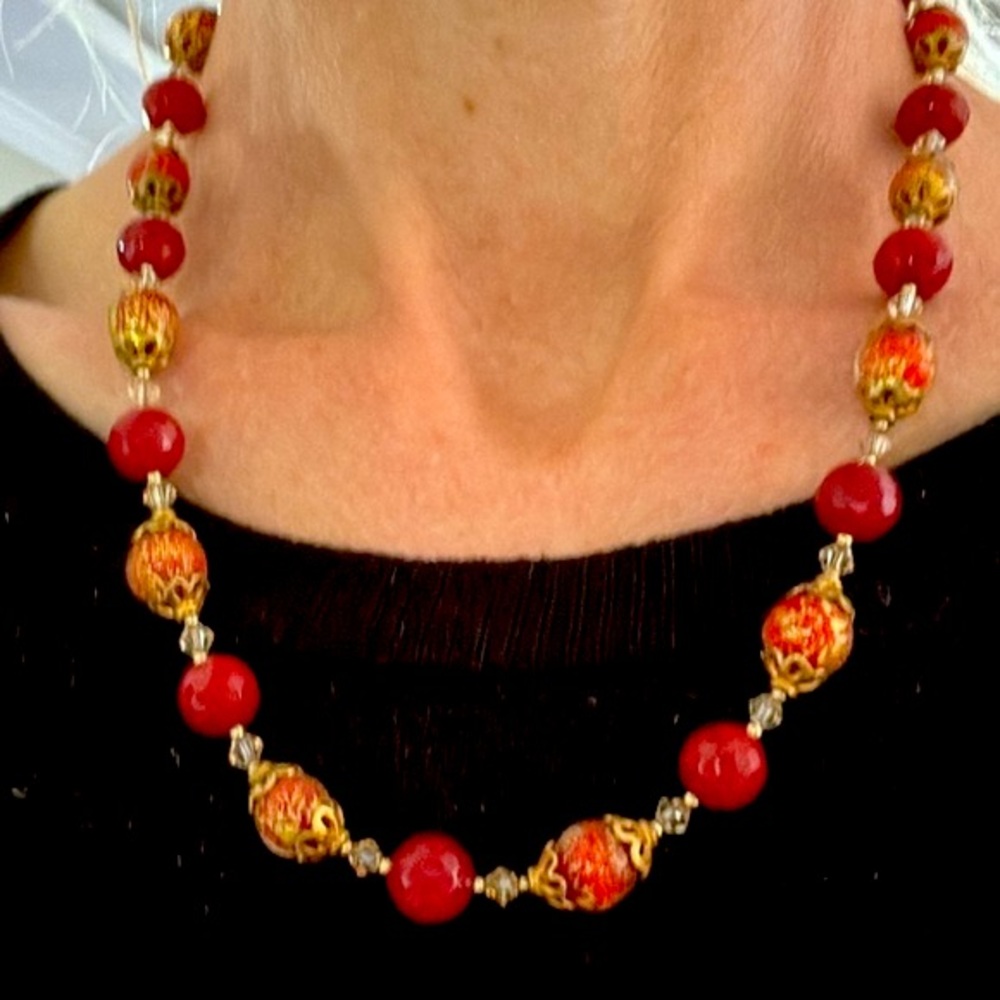 Necklace with speckled colors and red glass sphere beads on gold